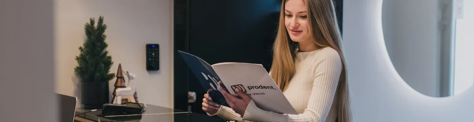 A patient at the ProDent reception desk in Nysa