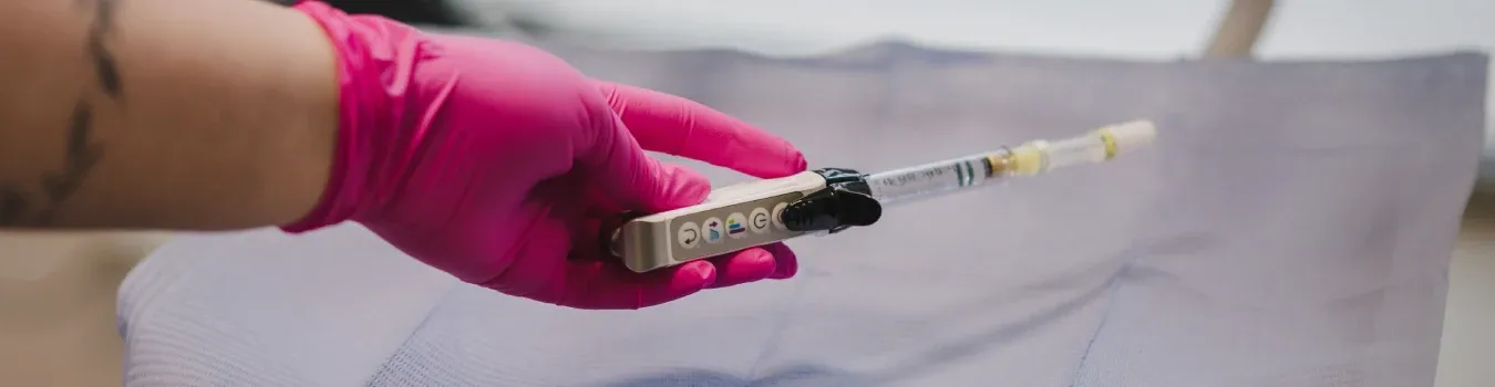 A clinician holding the Dentapen local anaesthetic applicator